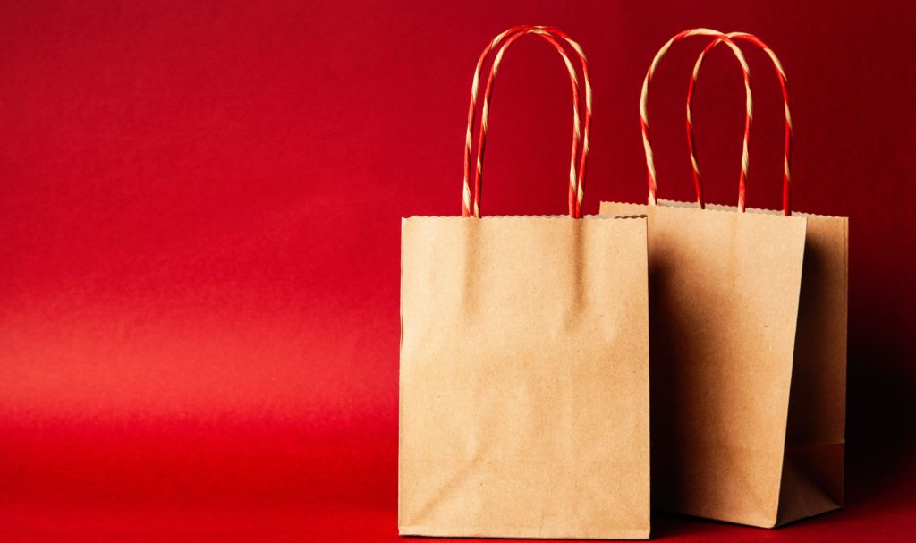 Product descriptions blog - Two brown paper bags on a red background